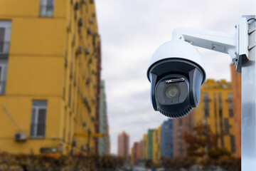 Modern public CCTV camera with blur building background. Recording cameras for monitoring all day and night. Concept of surveillance and monitoring with copy space.