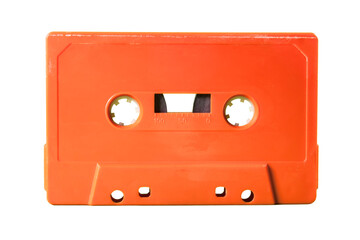 Isolated old vintage cassette tape from the 1980s (obsolete music technology). Vivid colors: coral...