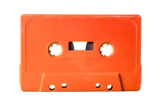 Isolated old vintage cassette tape from the 1980s (obsolete music technology). Vivid colors: coral red plastic body, no label.
