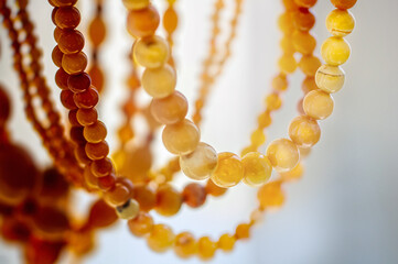 Various amber beads on a  bright background