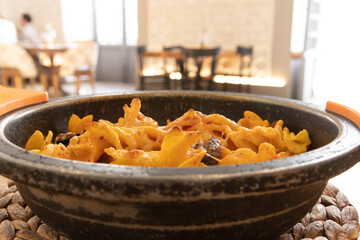 Arrabiata gratin pasta, an Italian dish. Inside a restaurant. Italian food concept.