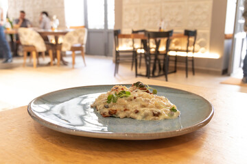 Risotto gorgonzola, an Italian dish. Inside a restaurant. Italian food concept.