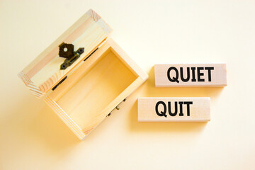 Quiet quit symbol. Concept words Quiet quit on wooden blocks. Beautiful white table white background. Empthy wooden chest. Business and quiet quit concept. Copy space.