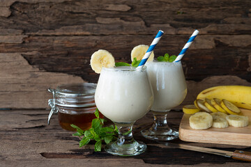 Banana fresh cocktail vanilla smoothies  fruit juice beverage healthy the taste yummy in glass drink episode good morning on wooden background.