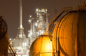 A large oil-refinery plant with Liquefied Natural Gas - LNG - storage tanks