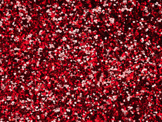 Red glitter. Perfect holographic background or pattern of sparkling shiny glitter for decoration...