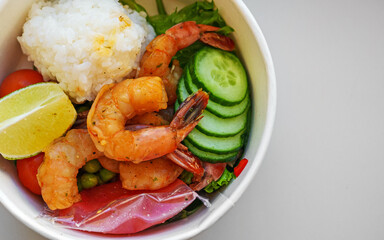 Store-bought poke bowl with shrimp and rice.