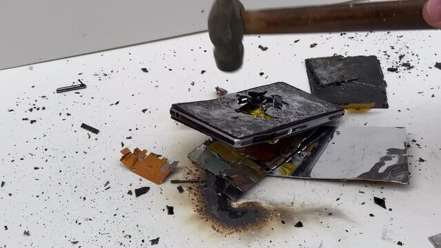 Broken phone. Hammer hitting the display breaks the mobile phone. Mobile smartphone with a broken screen. Drop Test. Hammer Durability. Hammer vs mobile display. Smashing the Phone. Breaking display.