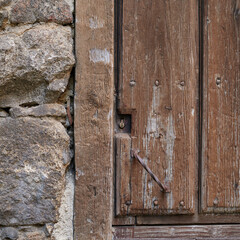 Old, picturesque main front door in mediterranean region house.