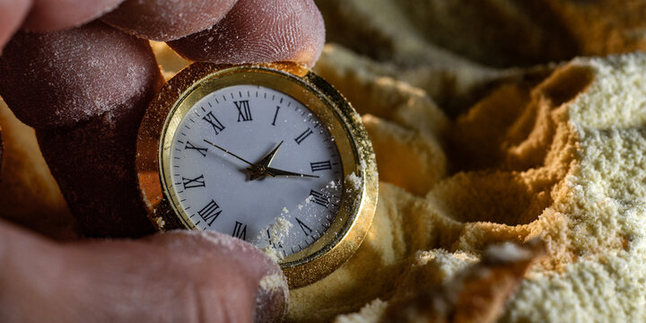 Close-up of mechanical watch held by fingers
