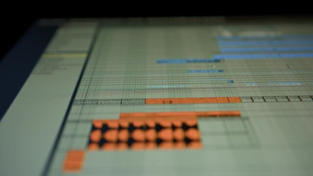 Music sequencer - a sound wave and a playhead moves along it. The process of creating music on a computer, a screen