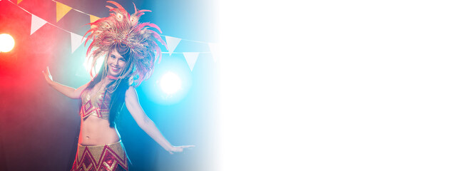 Fototapeta na wymiar Banner Cabaret, dancer and holidays concept - Cute young girl in bright colorful carnival costume on dark background with copy space
