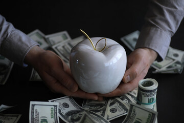 Apple on table with money, dollars banknotes. Us business concept. New york big apple.
