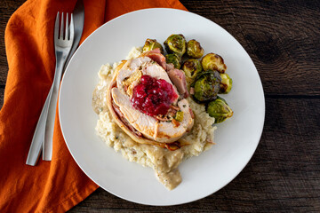 Thanksgiving Turkey Roll Dinner with Mashed Potatoes and Brussels Sprouts: An alternate Thanksgiving dinner topped with gravy and cranberry sauce