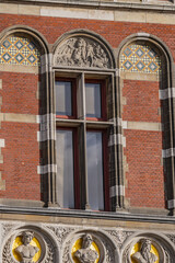 Architectural fragments of historic building of Amsterdam central railway station (opened in 1889). Amsterdam, the Netherlands.