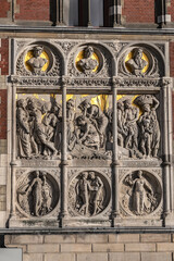 Architectural fragments of historic building of Amsterdam central railway station (opened in 1889). Amsterdam, the Netherlands.