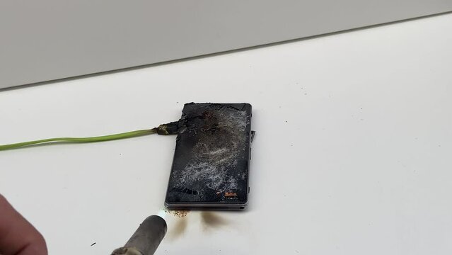 Broken phone. Hammer hitting the display breaks the mobile phone. Mobile smartphone with a broken screen. Drop Test. Hammer Durability. Hammer vs mobile display. Smashing the Phone. Breaking display.