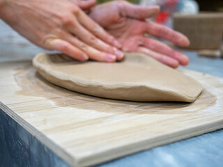 Close-up of the master sculpts a tablet from clay. Handmade, Workshop, Selective focus, exclusive