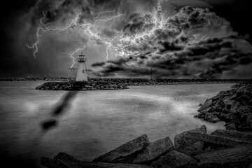 The lighthouse in the small Ontario town of Prescott is seen during a colourful lightning storm over Lake Ontario. Black and white.