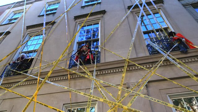 Skeleton bones are decorated at windows and a monster is on iron fence of apartment for annual Halloween decoration in Upper East Side Manhattan on October 30, 2022 in New York City NY, USA.