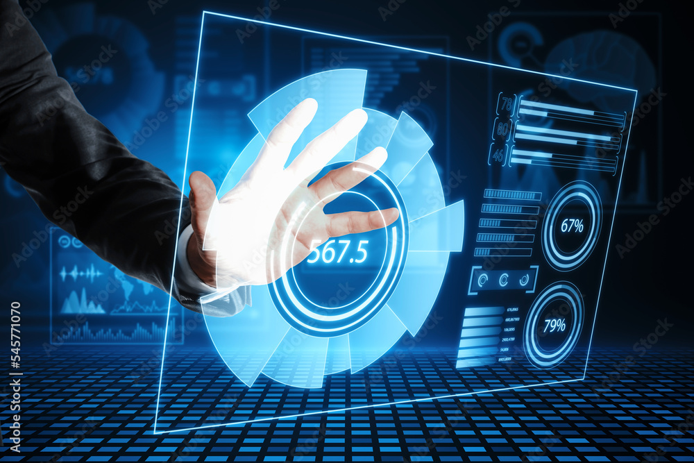 Poster close up of businessman hand using abstract glowing blue business charts and graphs hologram on dark