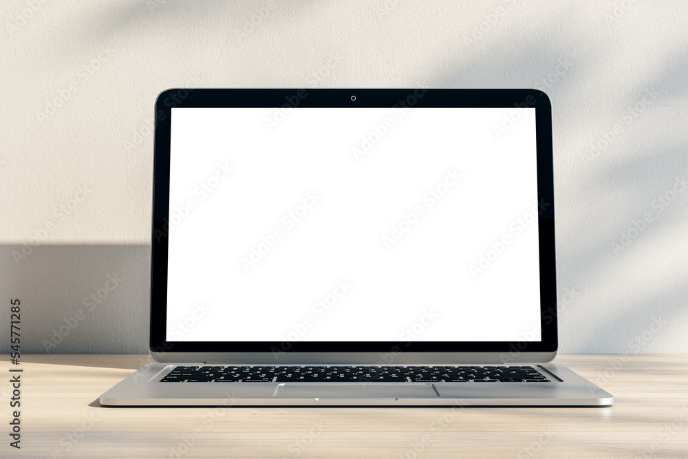 Poster closeup of modern laptop with blank white screen and place for your logo or text on light wooden tab