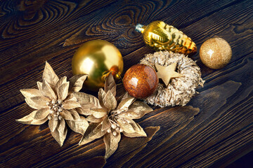 Christmas decorations. New Year's decorations on a dark wooden background. Garlands, balls and toys for Christmas decor. Festive postcard.