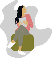 The girl is sitting on an ottoman with a tablet
