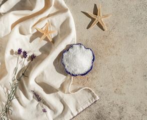 Sunny composition with Epsom salt in the plate with lavender. 