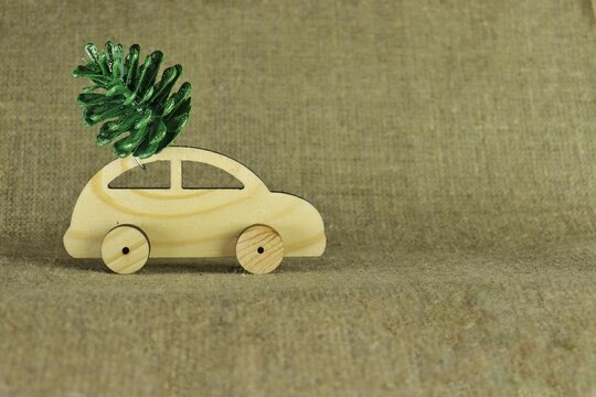 Wooden machine with a Christmas tree cone on canvas.