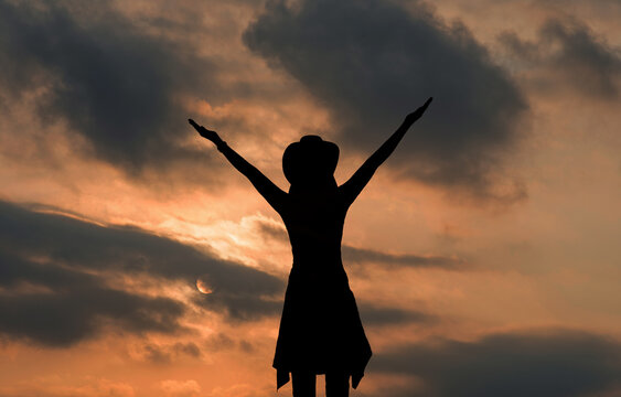 Woman silhouette, business success, business victory , hands in the air Sun len glare effect