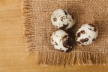 Quail eggs on a wooden table.