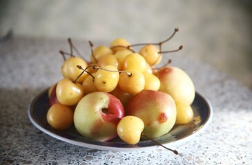 Naklejka na ściany i meble white cherries and pears on the plate