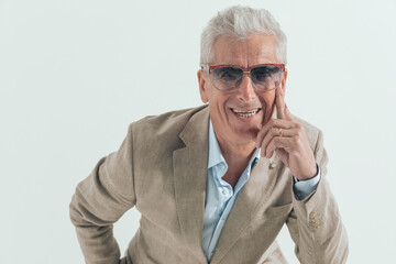 happy old man with grey hair wearing sunglasses laughing