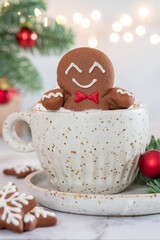 Gingerbread cookie man with a hot chocolate for Christmas. Traditional holiday symbol. Christmas holiday background.
