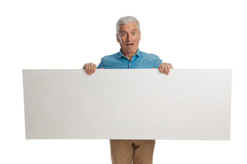 surprised old man holding empty white board and showing