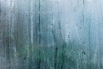 Natural water drop on glass. Misted glass in fall, autumn background. Condensation water droplets. Abstraction