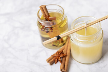 Soy candles handmade with wooden wicks. Handmade craft candles. Vegan product. Glass jars with soy wax on a marble table.