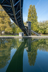 Paris, France - 11 12 2022: Villette Canal. Reflections on the Ourcq canal of a bridge at sunrise