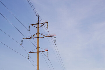power line tower with blue sky background