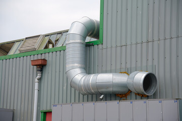 Flue chimney fixed to building exterior wall stainless steel from exhaust boiler plant room