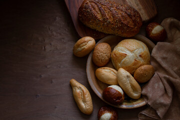 Mini Bread and Rolls on Wood Surface with Shadows