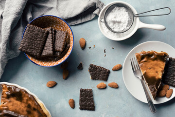 Cake and cookies on a plate for dessert. Delicious food. Homemade cheesecake with sugar on a backroud for christmas. Top view.	