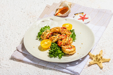Grilled shrimp salad with lettuce, tomato cherries and spices on a plate. Fresh and healthy seafood