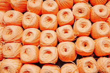 orange woolen threads in a ball for knitting close-up