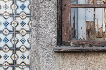 Old ruined domestic house facade building with typical tiled facade wall in Porto, Portugal close up still