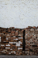 Old bricks against white brick wall	