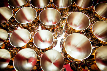 Rows of stamped hemispherical goblets made of steel with external inlay.