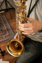 Hands of a musician playing the saxophone in a rehearsal room