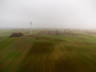 Fototapeta na wymiar Wind turbine in the fog, alternative energy